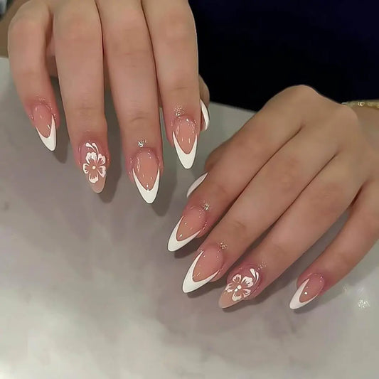 Close-up of hands with pink and white nail design on a neutral background