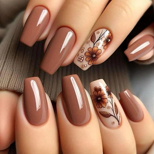 Nails with brown and beige color scheme and floral designs.