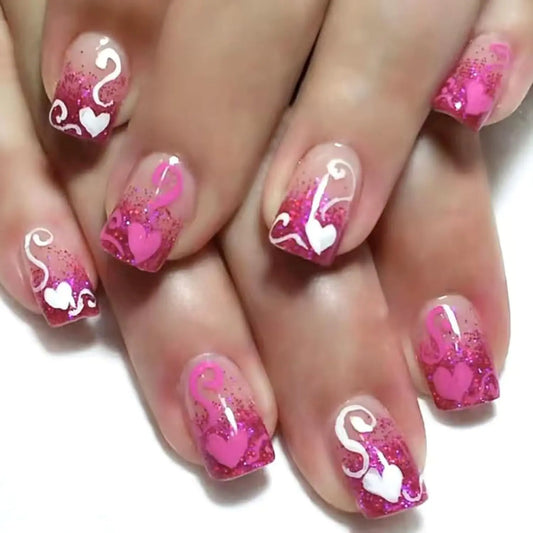 Nails with pink and white designs on a white background