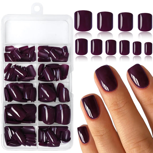 Set of dark purple nail tips in a organizer with a hand wearing the nails.